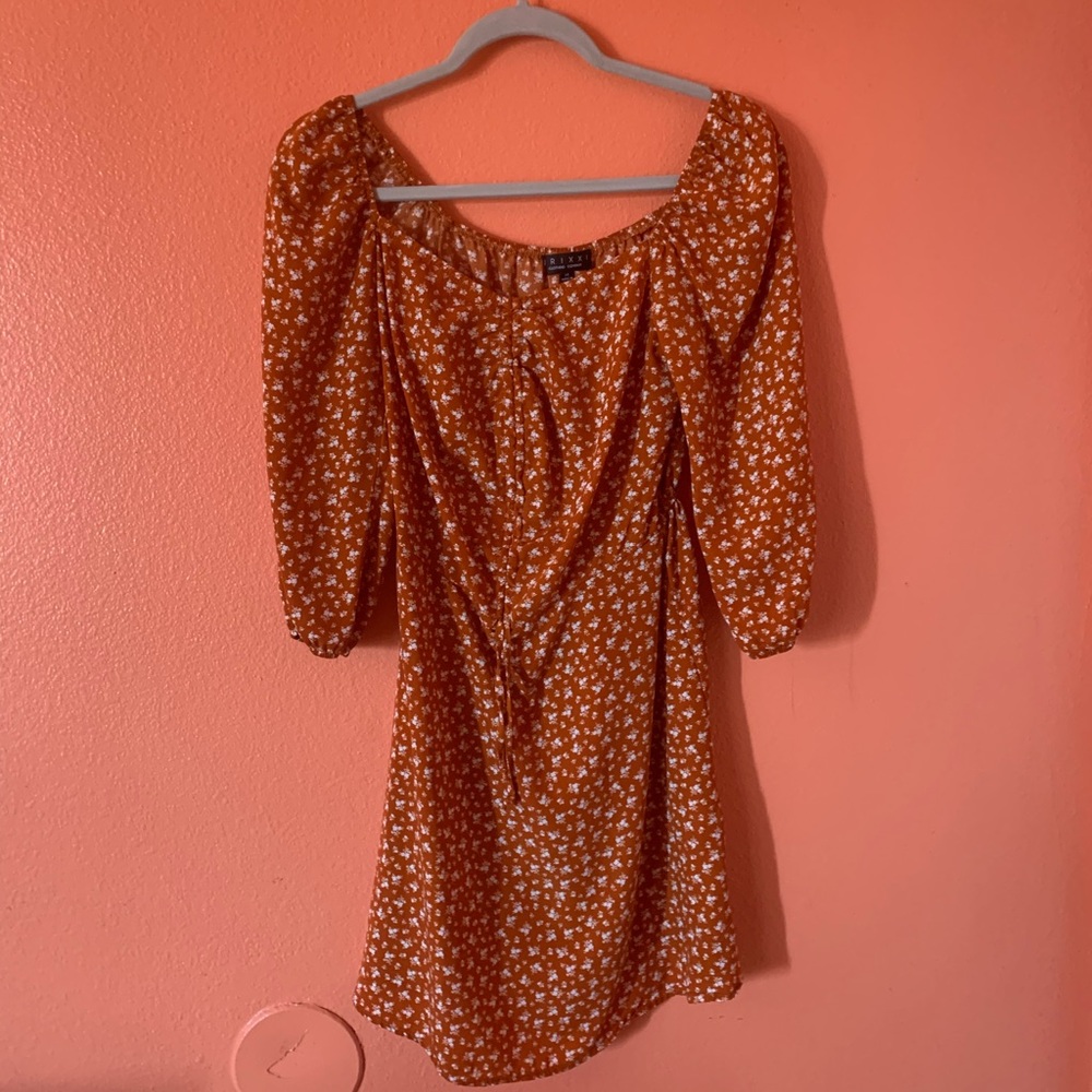 Orange off the shoulder dress with white flowers